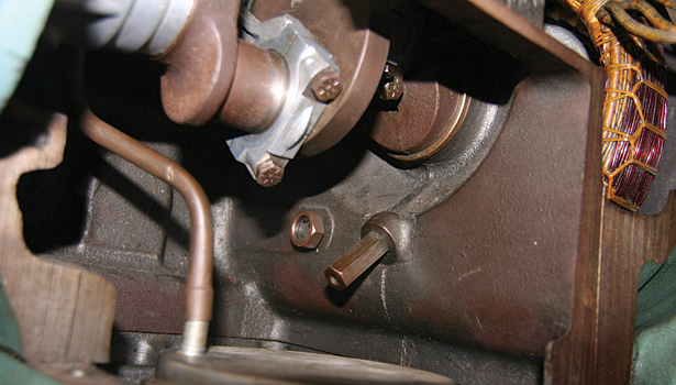 The partition wall, which separates the motor barrel from the compressor's crankcase, has an oil check valve that will only let oil pass from the compressor's motor barrel to its crankcase.