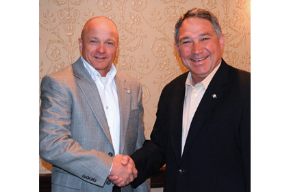 Tom Huntington (right), president and CEO, WaterFurnace Intl. Inc., congratulates Enertech Global president and CEO Steve Smith (left) on his election as chairman of the Geothermal Exchange Organization (GEO).