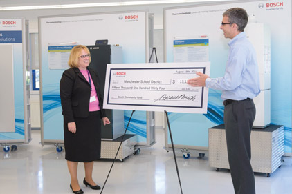 Pictured here, Debra Livingston (left), superintendent, Manchester West High School, accepts the check from a Bosch representative (right). 
