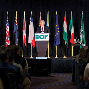IIAR outgoing chairman Marcos Braz addresses IIAR members during the organizationâ??s 2015 business meeting. (Photo courtesy of IIAR)