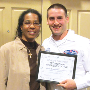 EXCEEDING EXPECTATIONS: At Bell Brothers, a customer presented her own award to technician Justin Engelleiter for providing great service and exceeding her expectations.