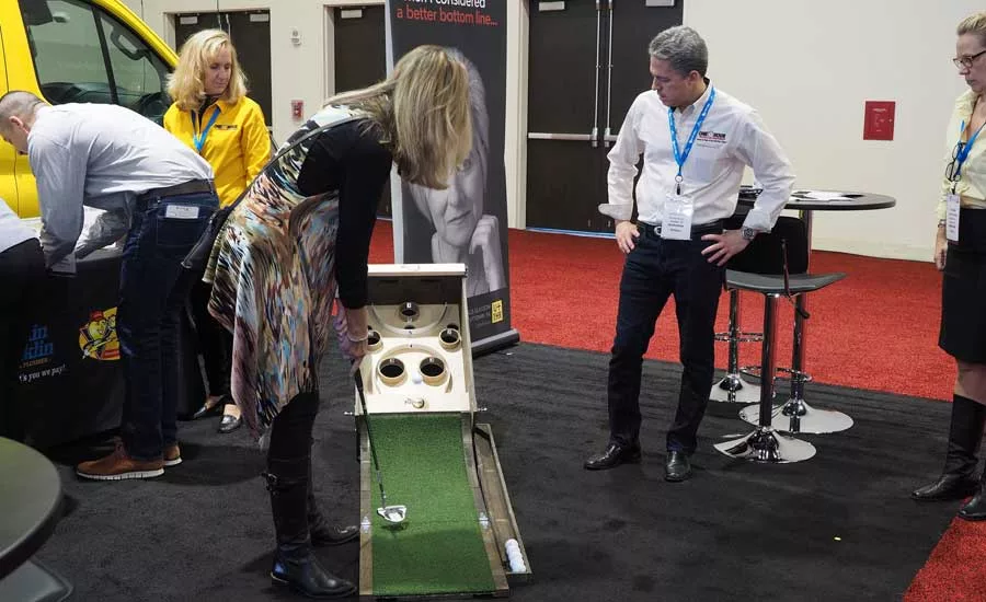 An ACCA attendee showcased her golf game at the One Hour booth. - The ACHR News
