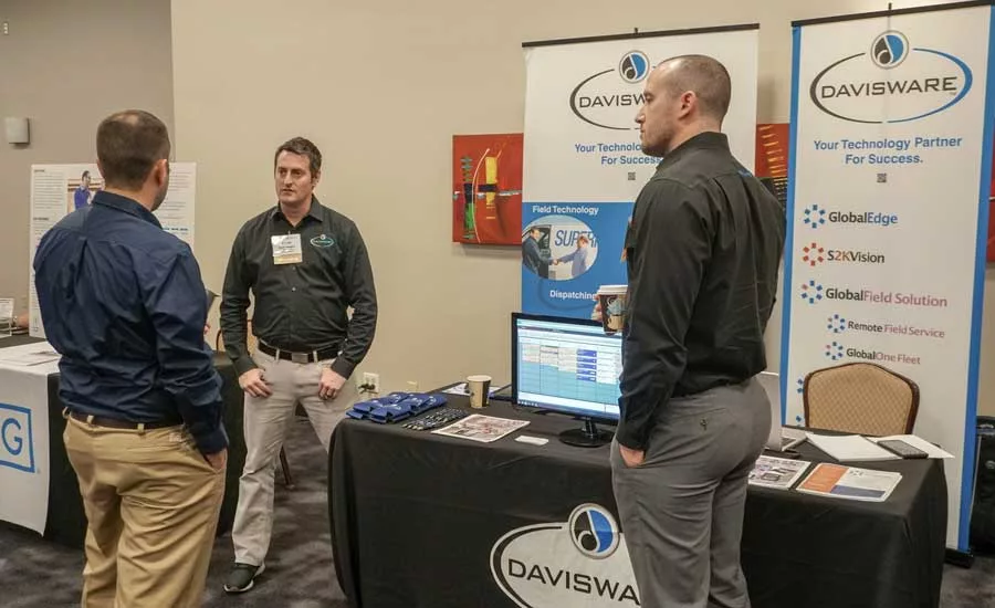 A conference attendee stops by the Davisware booth. - The ACHR News