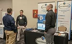 A conference attendee stops by the Davisware booth. - The ACHR News