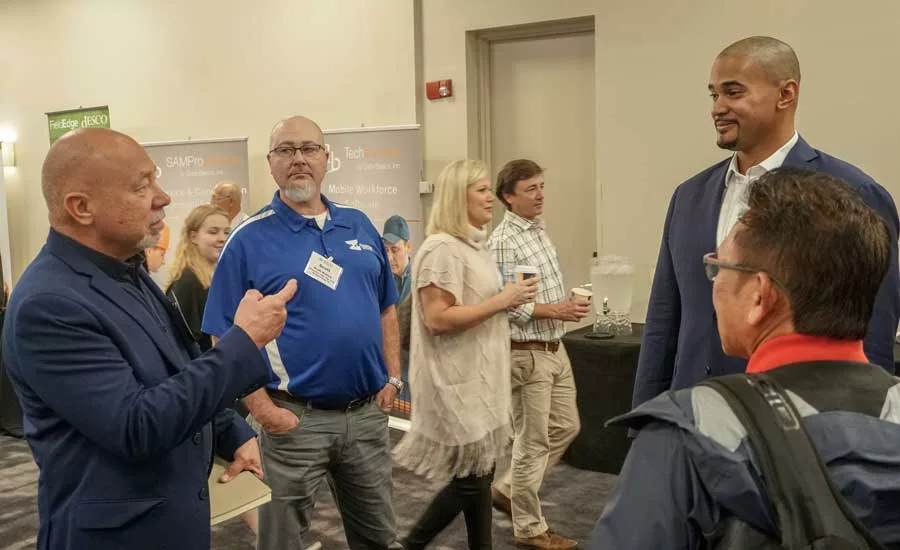 Consultant Frank Besednjak talks with former NFL player and fellow speaker Ryan Harris. - The ACHR News