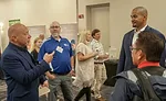 Consultant Frank Besednjak talks with former NFL player and fellow speaker Ryan Harris. - The ACHR News