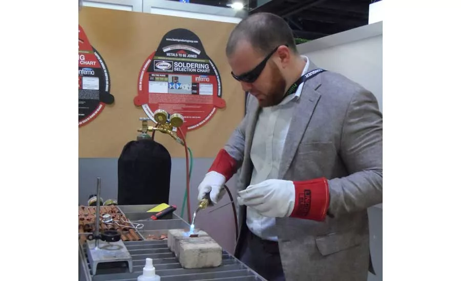 The Harris booth had instructors on-hand who could help attendees try their hand at brazing and soldering. - The ACHR News
