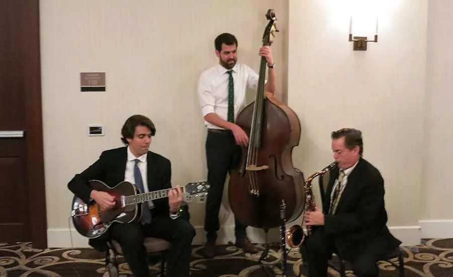 Trio bringing some holiday music to one company's festivities.