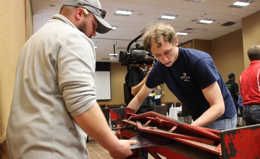 A technician practices with equipment during the second half of a hands-on session. - The ACHR News