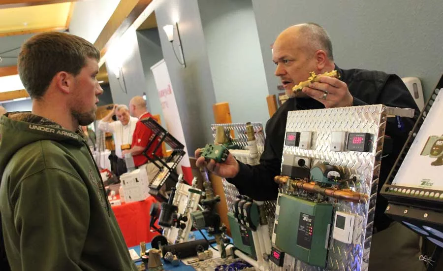 2019 Lennox VisionTECH Conference: A student visits a booth in the vendor hallway of the VisionTech conference. - The ACHR News.