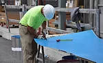 BGCAPP worker cuts insulation
