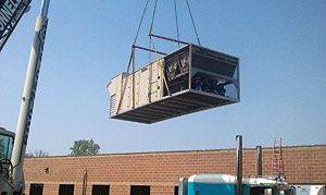 rooftop unit being lowered into place
