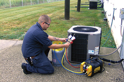 service technician recovering refrigerant