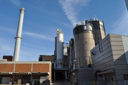Missouri Universityâs North Smoke Stack, Fuel Processing Building, and the Biomass and Coal Storage Silos are wedged between a power plant.