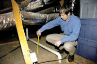Seth Rosser, United Energy conservation coordinator, measures insulation as part of an energy audit. Home-performance contracting is being heralded as "the next big thing"Â by many contractors.