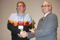 RSES Member of the Year Ray Clary, left, is congratulated by Lawrence Donaldson, who at the time of the presentation was RSES international president.