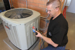 Journeyman Dan Tash from Sheet Metal Workers Local #359 in Phoenix checks on an air conditioning floor unit