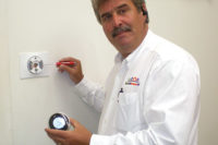Ed Carr, business solutions and development strategist with HouseCallCompany.com, Portsmouth, Va., demonstrates how to take apart a Nest thermostat. (Photo courtesy of Ed Carr/HouseCallCompany.com)