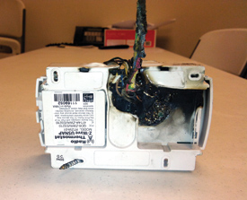 Troy Dassonville, owner of A/C Contractors, Longview, Texas, snapped this photo of a thermostat he said caught fire after being improperly installed in a Texas home by an alarm company.