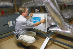 Howard Stalls of Environmental Air Conditioning Services, Jacksonville, Fla., installs an Ultra-Aire unit in a home.