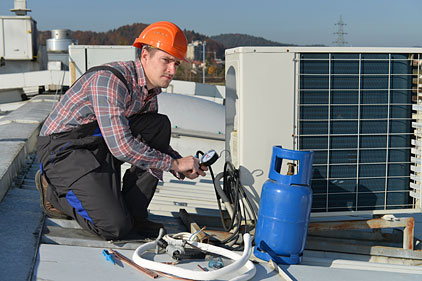 Technician servicing an HVAC unit