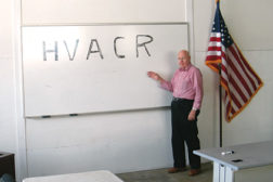 Aaron York Sr. stands at the white board of one of Yorkâ??s Quality Education & Training Center LLCâ??s new classrooms.
