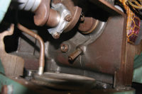 The partition wall, which separates the motor barrel from the compressor's crankcase, has an oil check valve that will only let oil pass from the compressor's motor barrel to its crankcase.