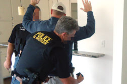 Police arrest an unlicensed contractor during a California licensing sting. (Photo courtesy of California Contractors State License Board)