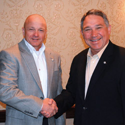 Tom Huntington (right), president and CEO, WaterFurnace Intl. Inc., congratulates Enertech Global president and CEO Steve Smith (left) on his election as chairman of the Geothermal Exchange Organization (GEO).