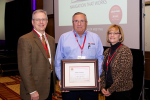 Doug Young, president of Behler-Young, presents Tier 3 MOE award to Dennis Meteer and Dorothy Tapling of Flame Furnace.