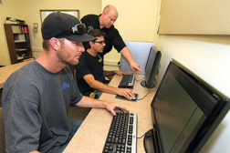 Jeff Proffitt, (top), assistant training director and instructor, Sheet Metal Training Center, Overton, Nevada, introduces first-year apprentices Juan Muniz (center) and Frank Damewood II (bottom) to AutoCAD.