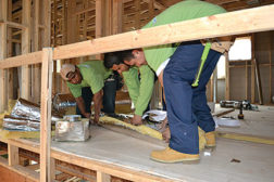 Installers from Vis Viva Energy and Services insulate sheet metal ductwork for a whole-house ducted mini-split system in a Georgia home designed by LG Squared Inc.