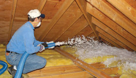 CertainTeedÃ¢??s TrueComfort system, shown here in an attic retrofit, includes a blowing machine and fiberglass blown-in insulation.