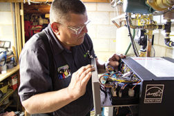 A technician installs U.S. Boilerâ??s Alpine boiler with Sage2.1 control. (Photo courtesy of U.S. Boiler Co.)