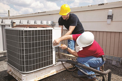 technicians working on a HVAC unit