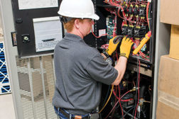 Joey Donithan, journeyman service technician, Crockett Facilities, Bowie, Maryland, performs preventive maintenance on a computer room a/c (CRAC) unit.