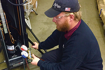 Ryan Brown, a technician for AirTight Mechanical in Charlotte, North Carolina, services a portable R-22 system used for data center hot spots. (Photo courtesy of AirTight Mechanical)