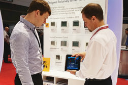 Mike Rimrodt (right), Aprilaire, shows Alex Fricke (left), Derse Inc., how to control a homeÃ?Â¢??s indoor environment remotely through a Wi-Fi-capable thermostat during the 2015 AHR Expo in Chicago.