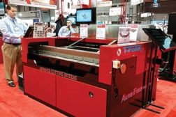 Clinton Ray Jr., national sales manager, Advance Cutting Systems, demonstrates the iFold, which features a small footprint and a price tag that puts it within reach of smaller businesses.