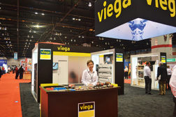 Dorothy Biggs, district sales manager, Viega, stands at the companyâ??s booth during the 2015 AHR Expo.