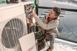 Dale Comeau, general manager of Comeau Refrigeration and Air Conditioning, Anapolis Royal, Nova Scotia, Canada, installs one of 79 Fujitsu RLXFZ units at Provident DevelopmentsÃ¢?? Dockside Waterfront Drive condominium development.