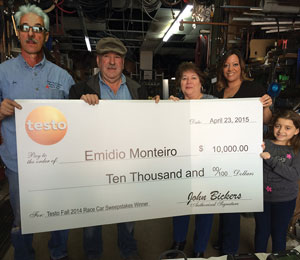 Emidio Monteiro (second to left), owner of Eurotech Climate Systems LLC, Pawtucket, Rhode Island, accepts his Testo Fall 2014 Race Car Trip Sweepstakes winning check with his family.