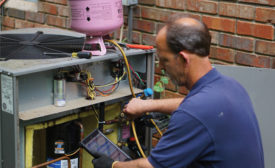 SMART TOOL: Ralph Wolf from T&N Services LLC, Canton, Georgia, uses the Sporlan SMART service tool on a service call.