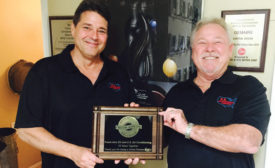 Alfred Cox (left) and Jeff Alloway (right), both directors at U.S. Air Conditioning & Heating (USAC), New Port Richey, Florida, show off the 28-year-old companyÃ¢â¬â¢s 10-year partnership anniversary award from Fresh-Aire UV.