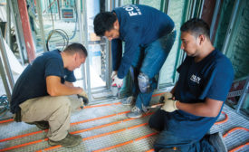 TUBING TRIO: Technicians for Foley Mechanical Inc. in Lorton, Virginia, secure Watts Radiant PEX tubing to the floor of a facility in Washington, District of Columbia.