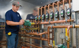 A technician wdith Woburn, Massachusetts-based Central Cooling & Heating Inc. completes a hydronic installation at a custom home near Boston.