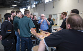 Instructor Frank Diaz provides instruction to students inside the One Hour Air Conditioning & Heating Technical Training Center at Suncoast Technical College.
