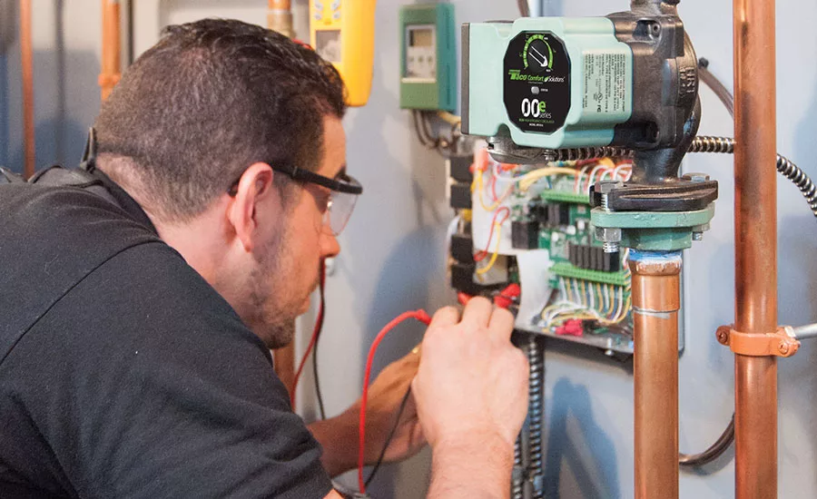 Anthony Tosco carefully wires together a new Taco 00e 1816 Delta-T circulator on a Pennsylvania job site.