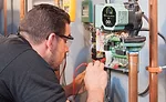 Anthony Tosco carefully wires together a new Taco 00e 1816 Delta-T circulator on a Pennsylvania job site.