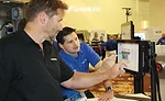 Chad Senger (right), product manager, Daikin Applied, demonstrates the effectiveness of the MicroTech Integrated Systems interface.